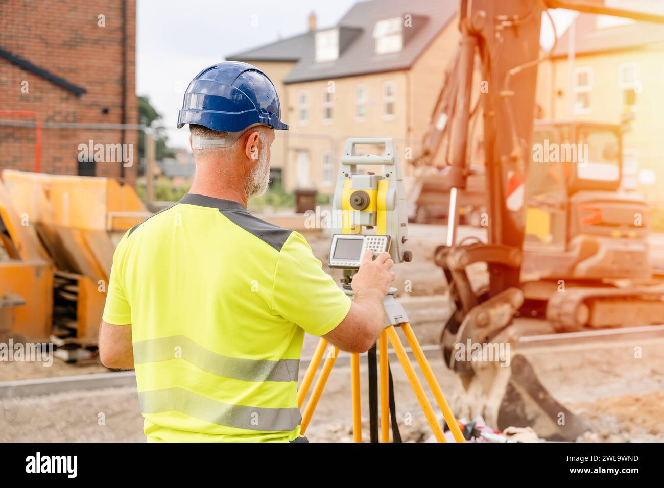 A man site engineer surveyor working with theodolite total station EDM ...