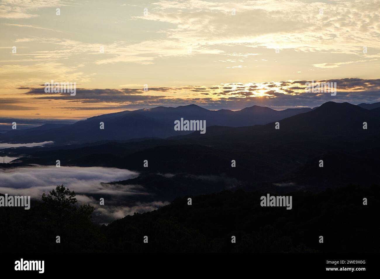 Misty Sunrise Over Smoky Mountains, Golden Sky View Stock Photo