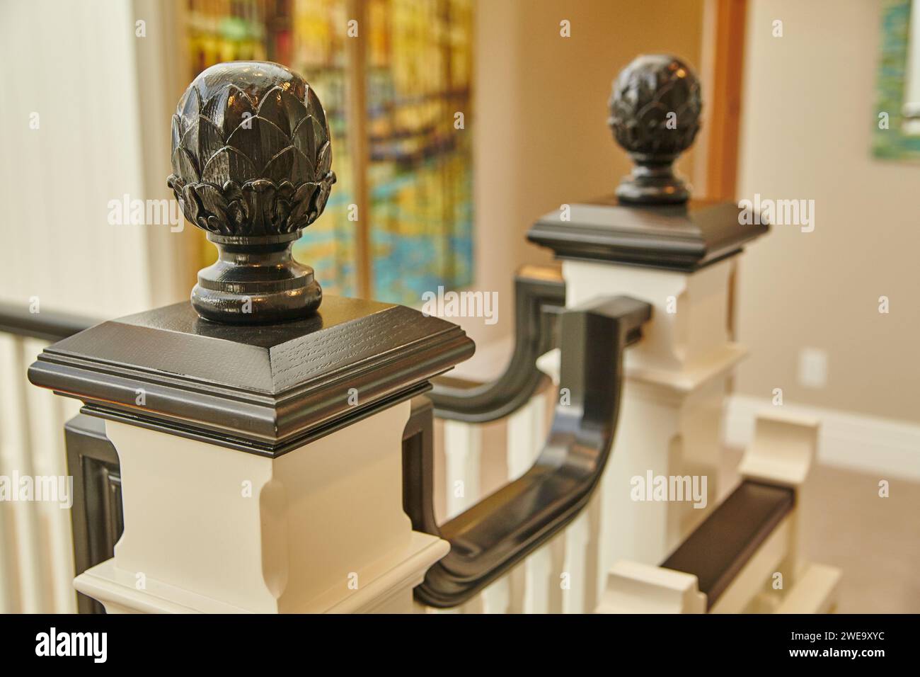 Luxurious Staircase Detail with Carved Newel Post Caps in Elegant Home Stock Photo
