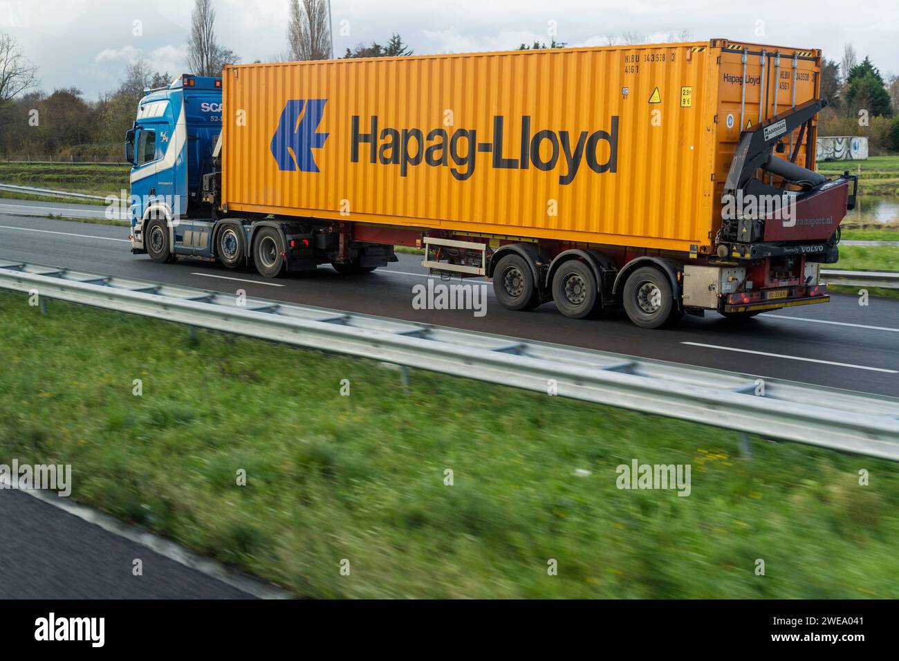 Amsterdam, Netherlands - December 7, 2022: A truck on the highway with a Hapag-Lloyd container *** Ein LKW auf der Autobahn mit einem Hapag-Lloyd Container Stock Photo
