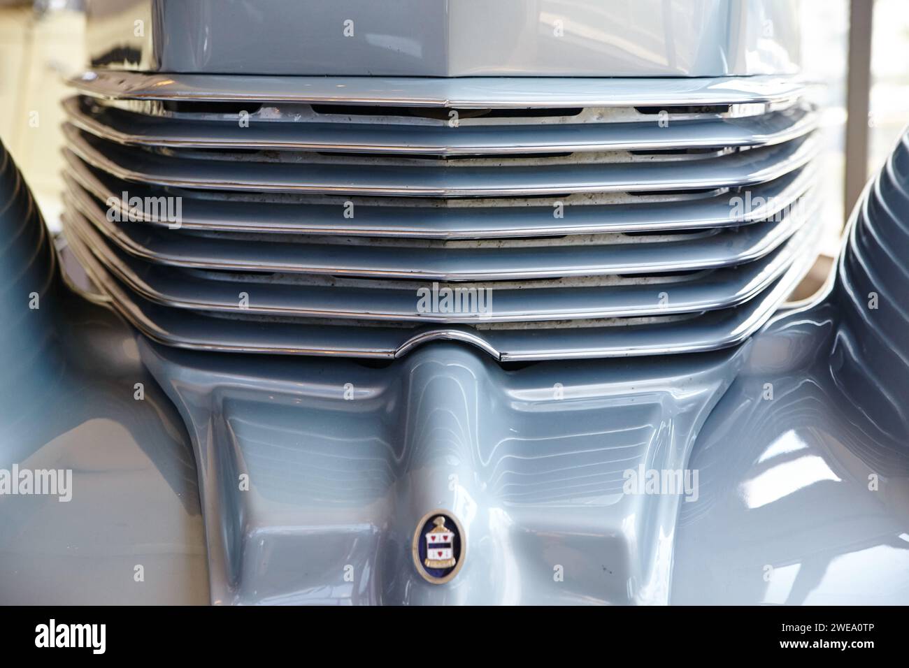 Luxury Car Grille Detail with Chrome Slats and Crest Emblem, Low Angle