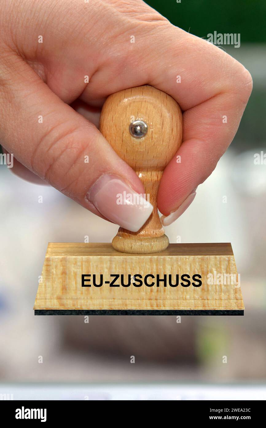 Hand mit Stempel, Frauenhand, Aufschrift: EU-Zuschuss, EU-Zuschuß, Kredite, Fördermittel, Stock Photo