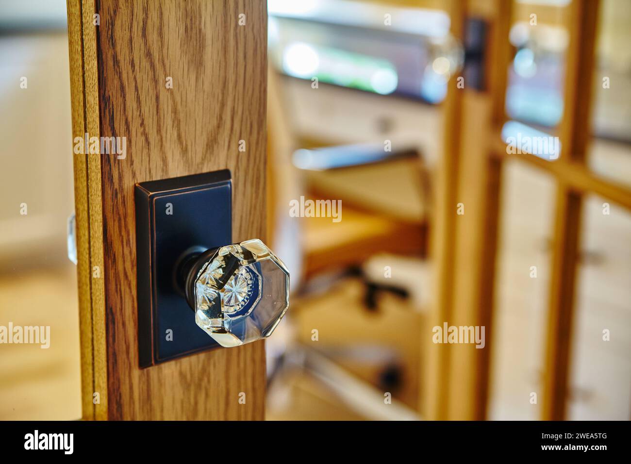 Elegant Wooden Door with Glass Knob, Warm Interior Bokeh Stock Photo