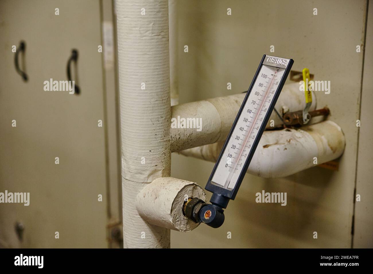 HVAC System Thermometer on Insulated Pipe in Utility Room Stock Photo