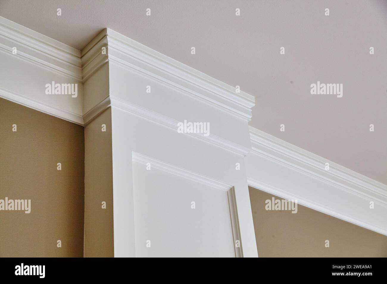 Elegant Crown Molding and Door Frame in Sophisticated Interior, Upward View Stock Photo