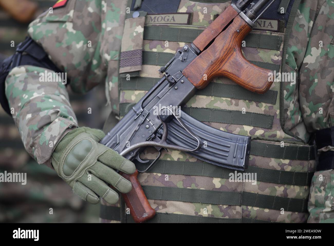 Bucharest, Romania - January 24, 2024: Details with a Romanian army soldier holding an AK 47 assault rifle during a military ceremony at the Monument Stock Photo