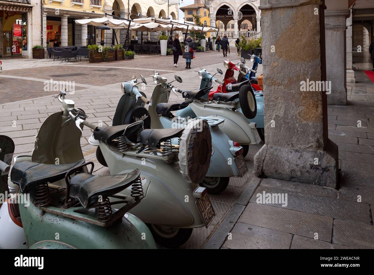 Udine, Italy (7th January 2024) - Old Vespa motorbikes of different colours aligned in the city center Stock Photo