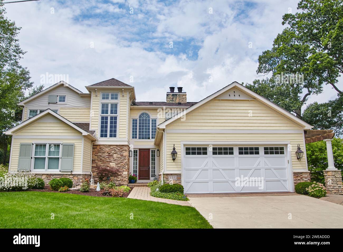 Classic American Suburban Home with Manicured Lawn and Pathway Stock ...