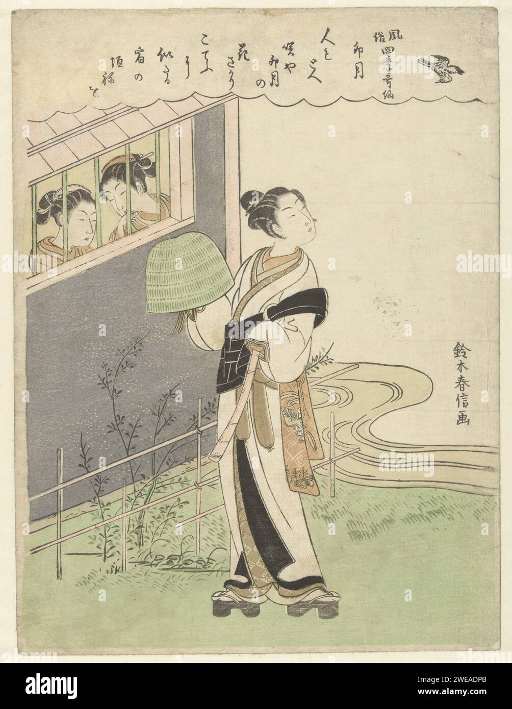 The fourth month, Suzuki Harunobu, 1765 - 1770 print Man (Komuso) with hat in the right and whistle in the left hand, standing by bamboo fence and river, looking up to Koekoek, while two girls watch him from behind a window. A poem in a cloud -shaped cartouche along the top of the print. Japan paper color woodcut adult man. head-gear. flute, aulos, tibia Stock Photo