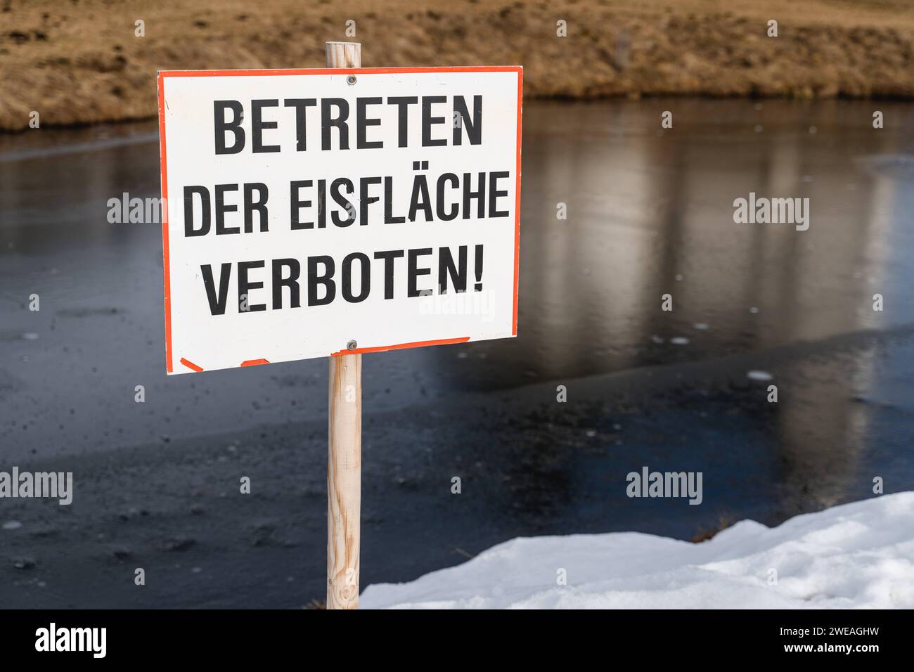 Austria January 8, 2023 Sign next to a frozen river with the