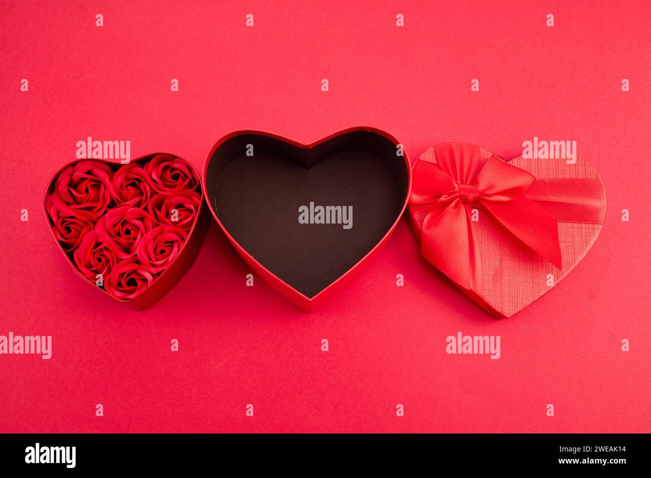 Heart shaped Gift box with roses for Valentine's Day on red background ...