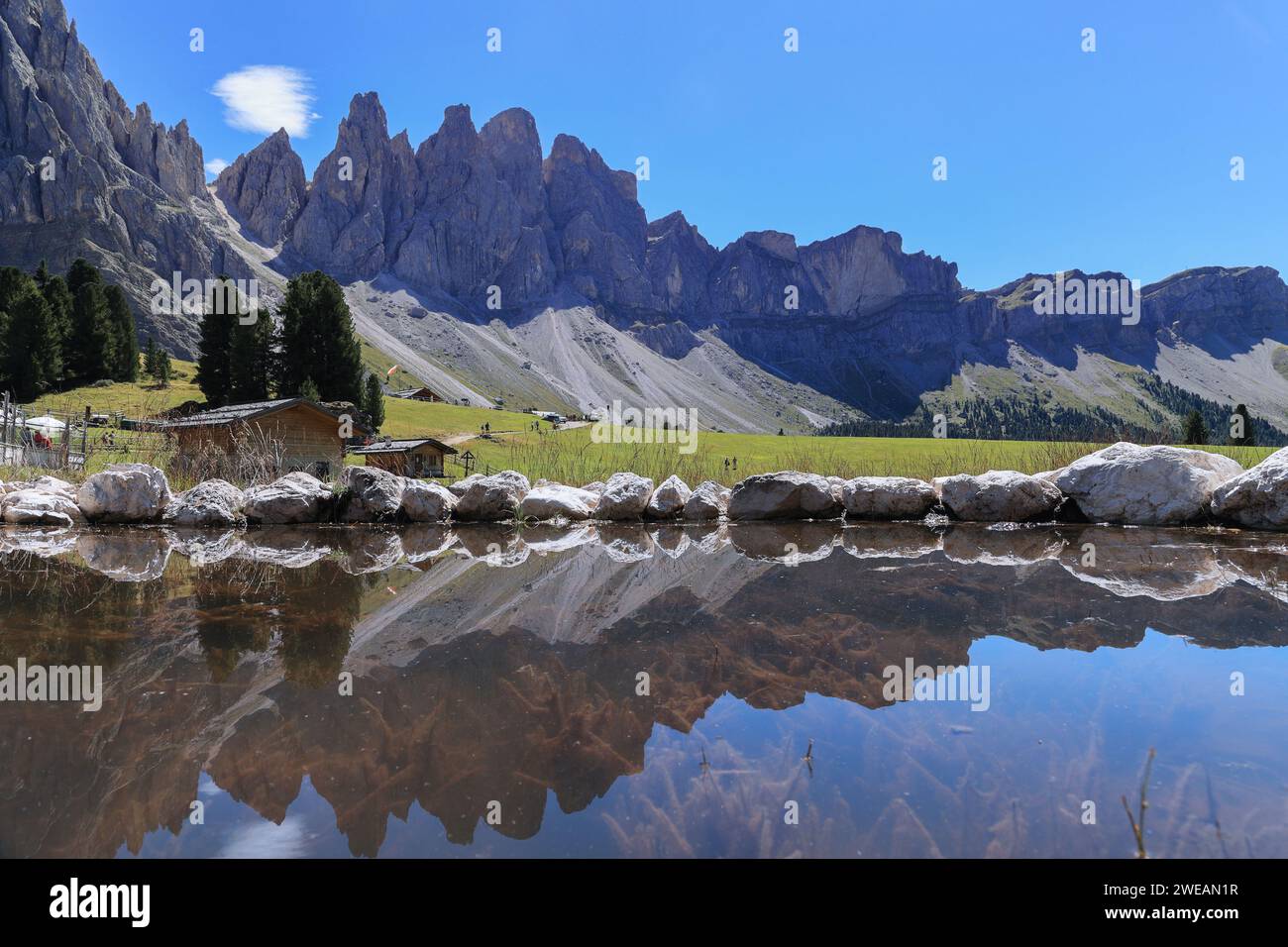 Reflection of Alpine peaks of Odle Group at Geisler Alm, Dolomites Italy, Val Di Funes Stock Photo