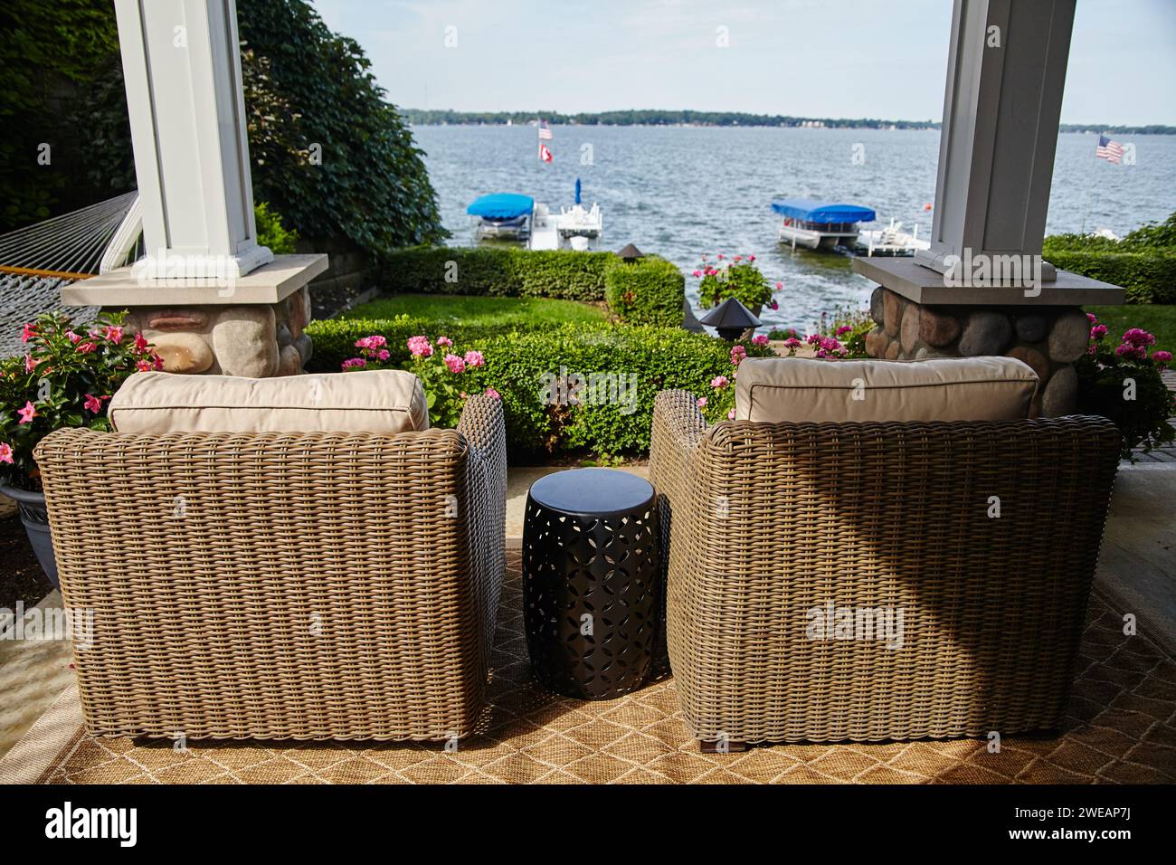 Lakeside Relaxation with Wicker Chairs and American Flag Stock Photo