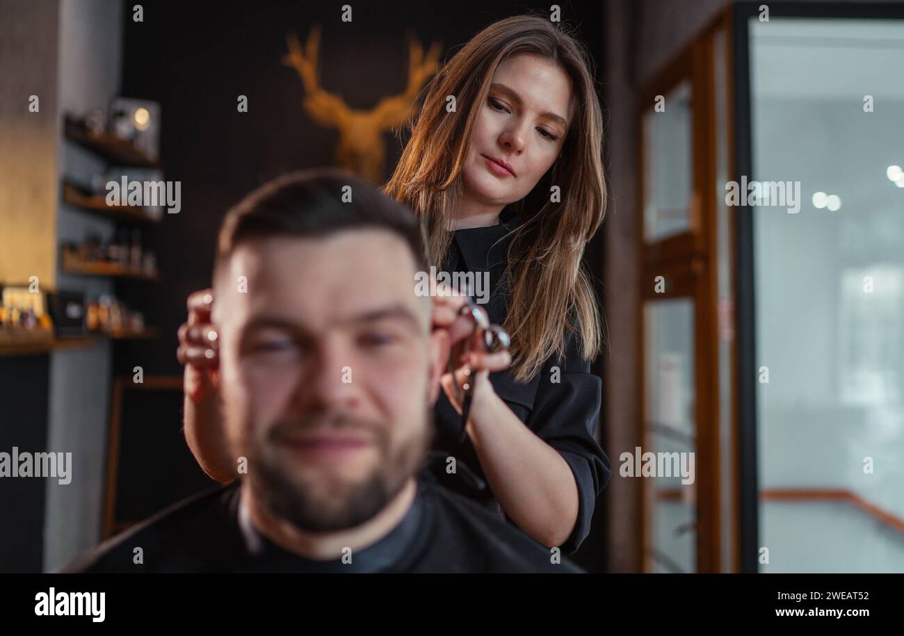 Hairdresser making haircut young man hi-res stock photography and ...