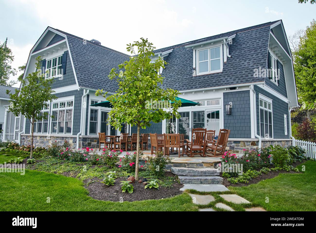 Modern Craftsman Home with Manicured Garden and Patio Set Stock Photo