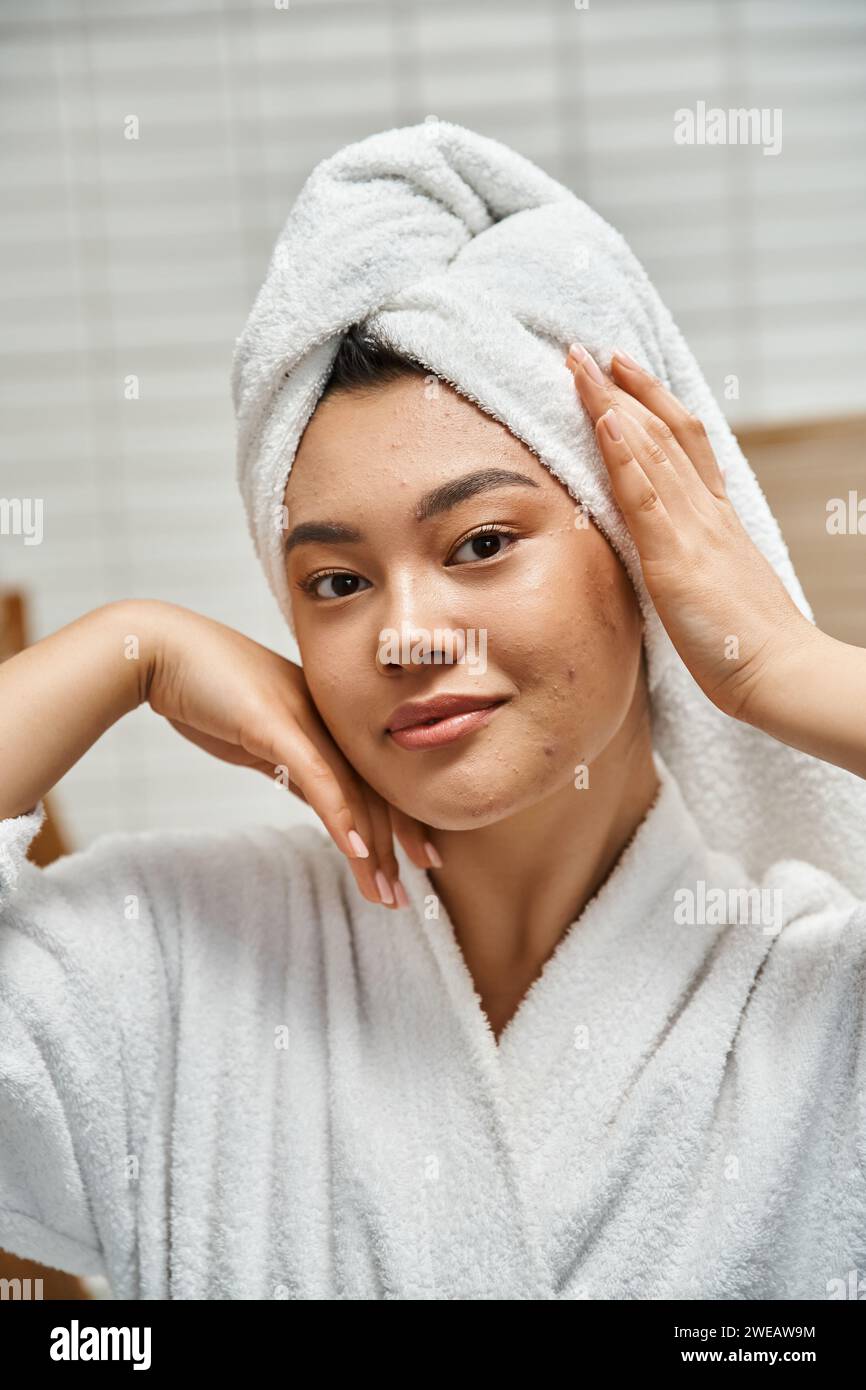 vertical shot of young asian woman with acne prone skin with white