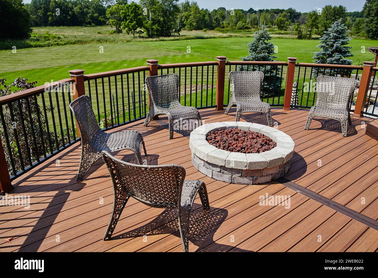 Sunny Outdoor Patio with Fire Pit and Wicker Chairs, Suburban Deck ...