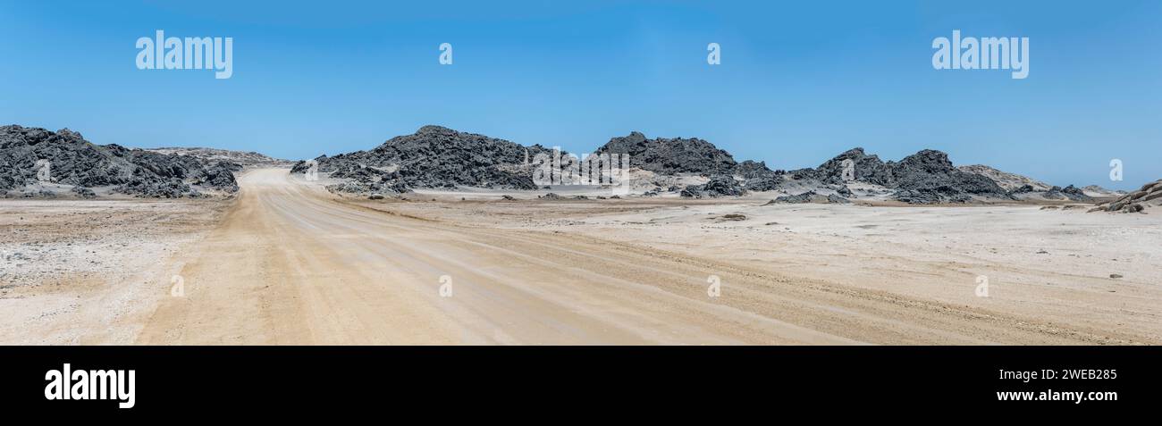 landscape with gravel road and basalt buttes near desert shore, shot in ...