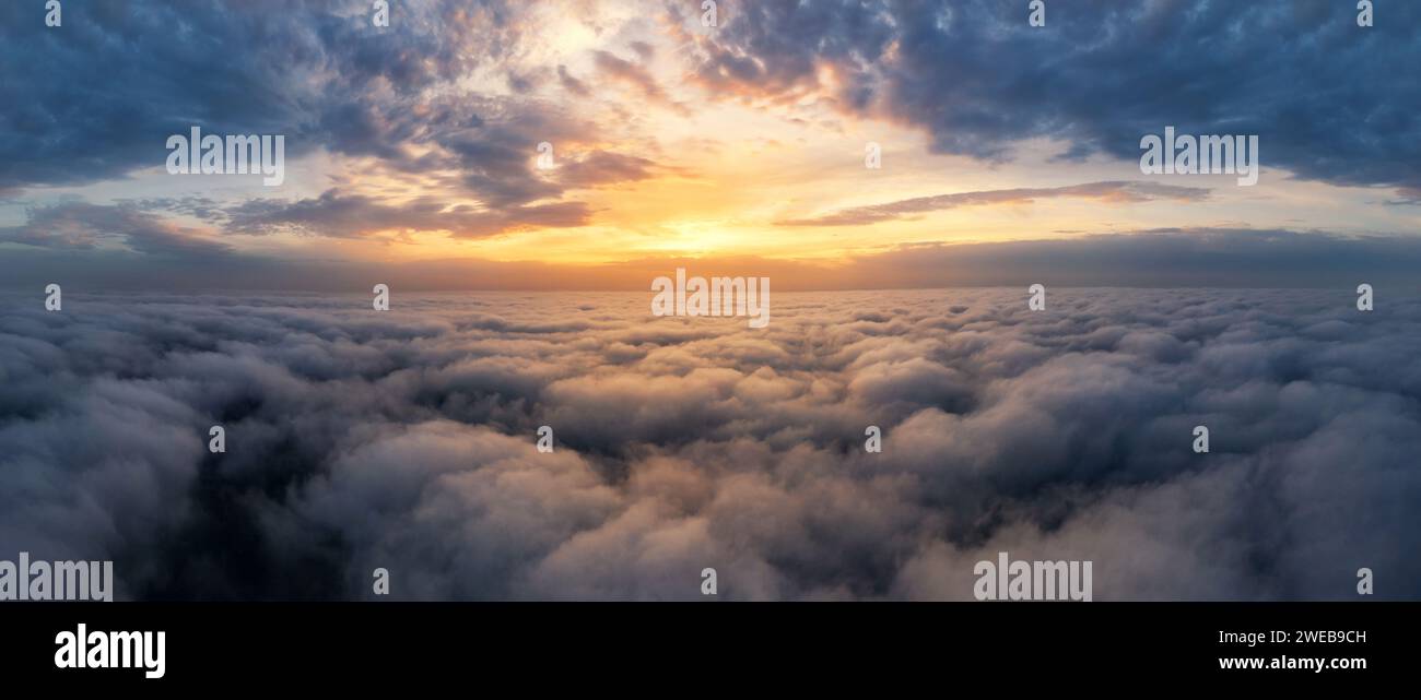 Beautiful dramatic sunset sky above fluffy clouds early in the morning ...