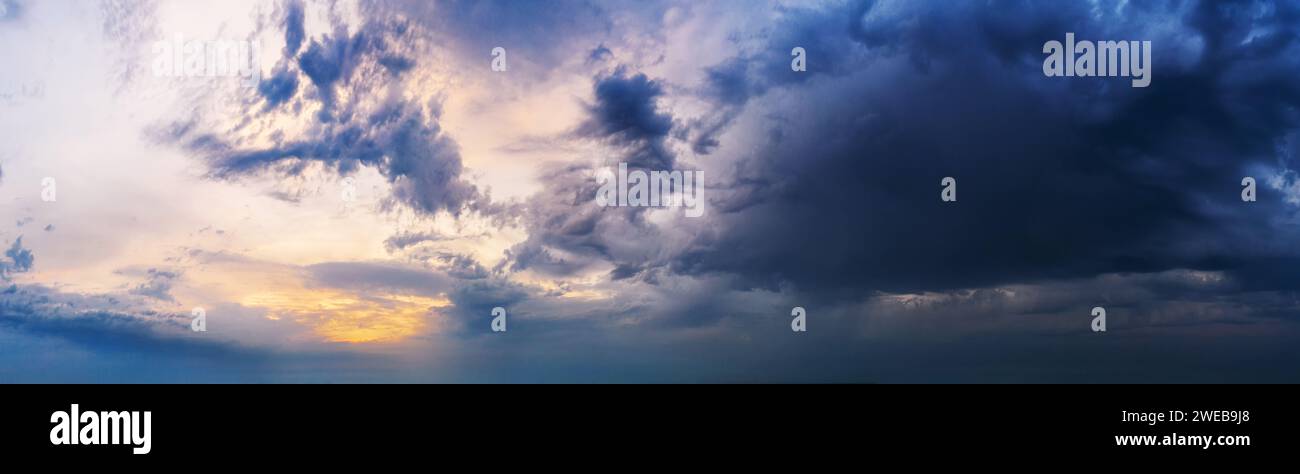 Dramatic sunset sky with dark clouds. Beautiful cloudscape at dusk. Stock Photo