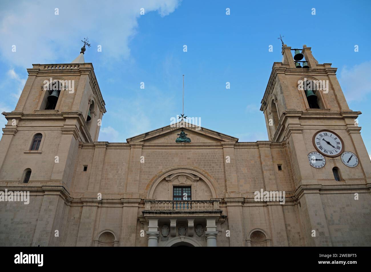 Facade of Valletta Cathedral with time and date and day clocks on the south bell tower Stock Photo