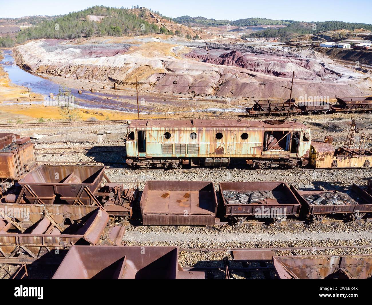 Aerial drone view of an old and rusty mining train used for transportation of the copper of  Corta Atalaya mining exploitation. Remains of the old cop Stock Photo