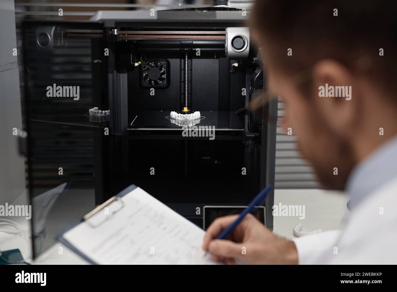 Technician Documenting Printed 3D Dental Prosthesis Stock Photo