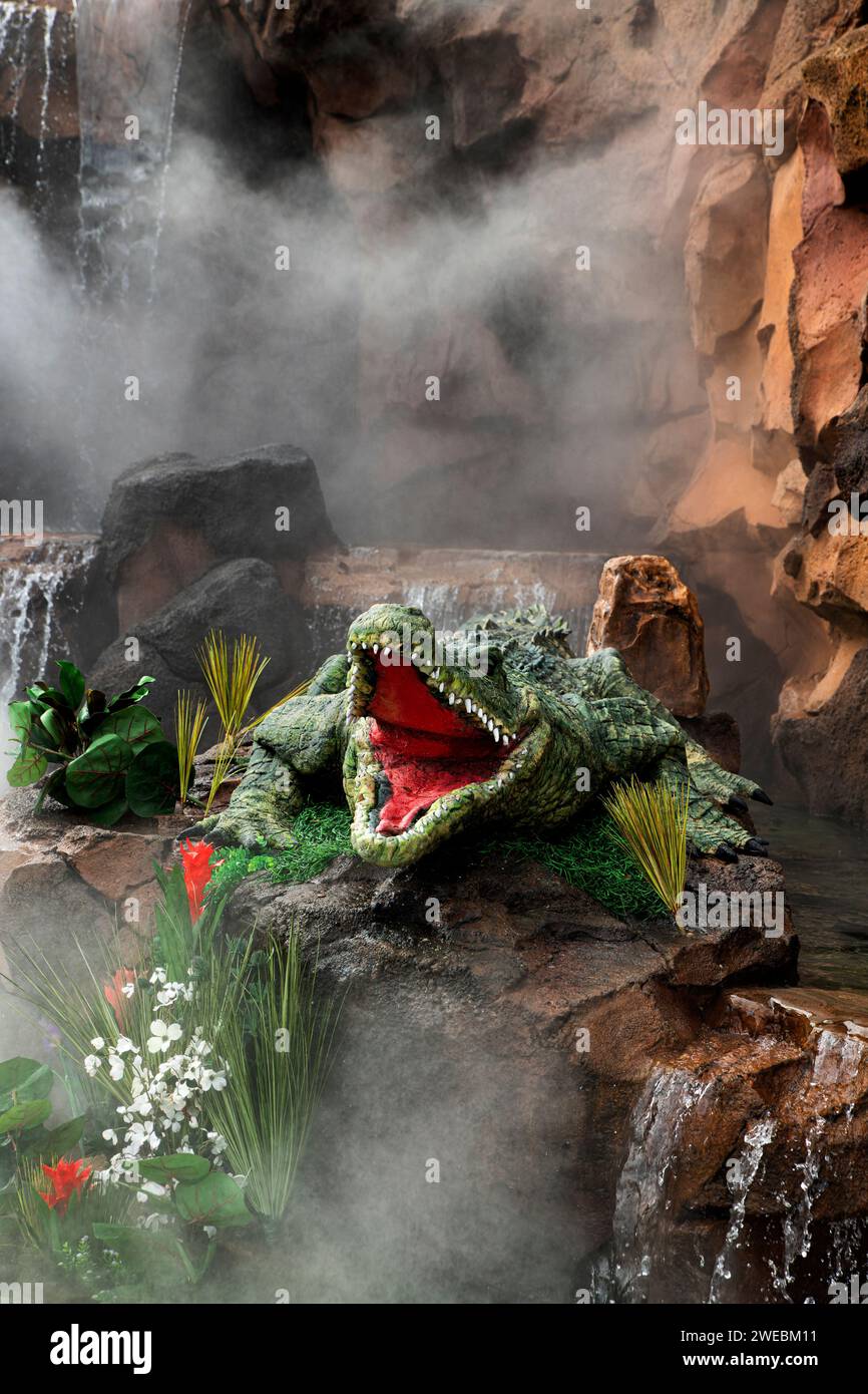 Hungry mechanical alligator guards the entrance to Disney's Rainforest Cafe restaurant. Stock Photo