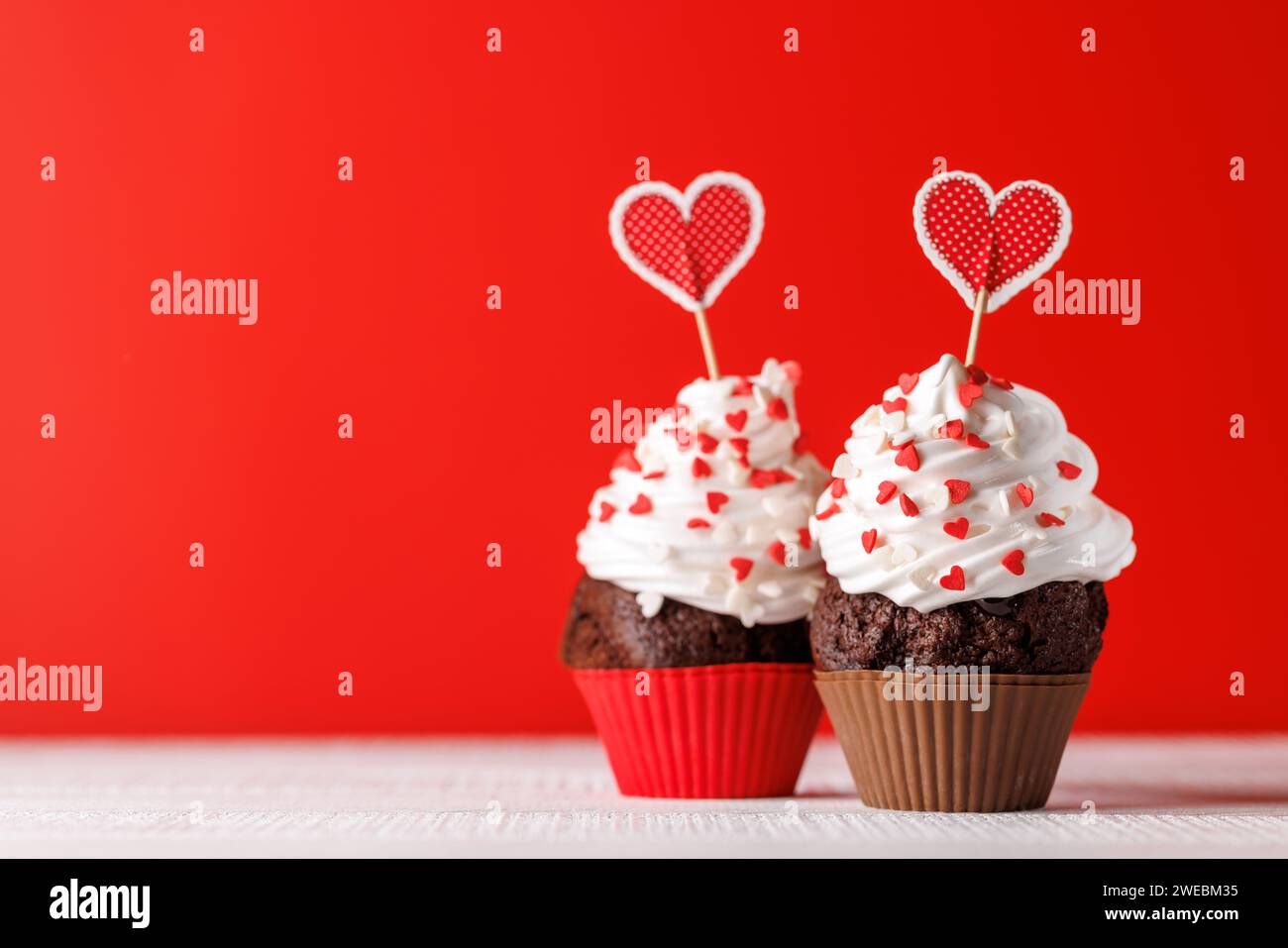Cupcake love Heartthemed treats on a vibrant red backdrop with copy