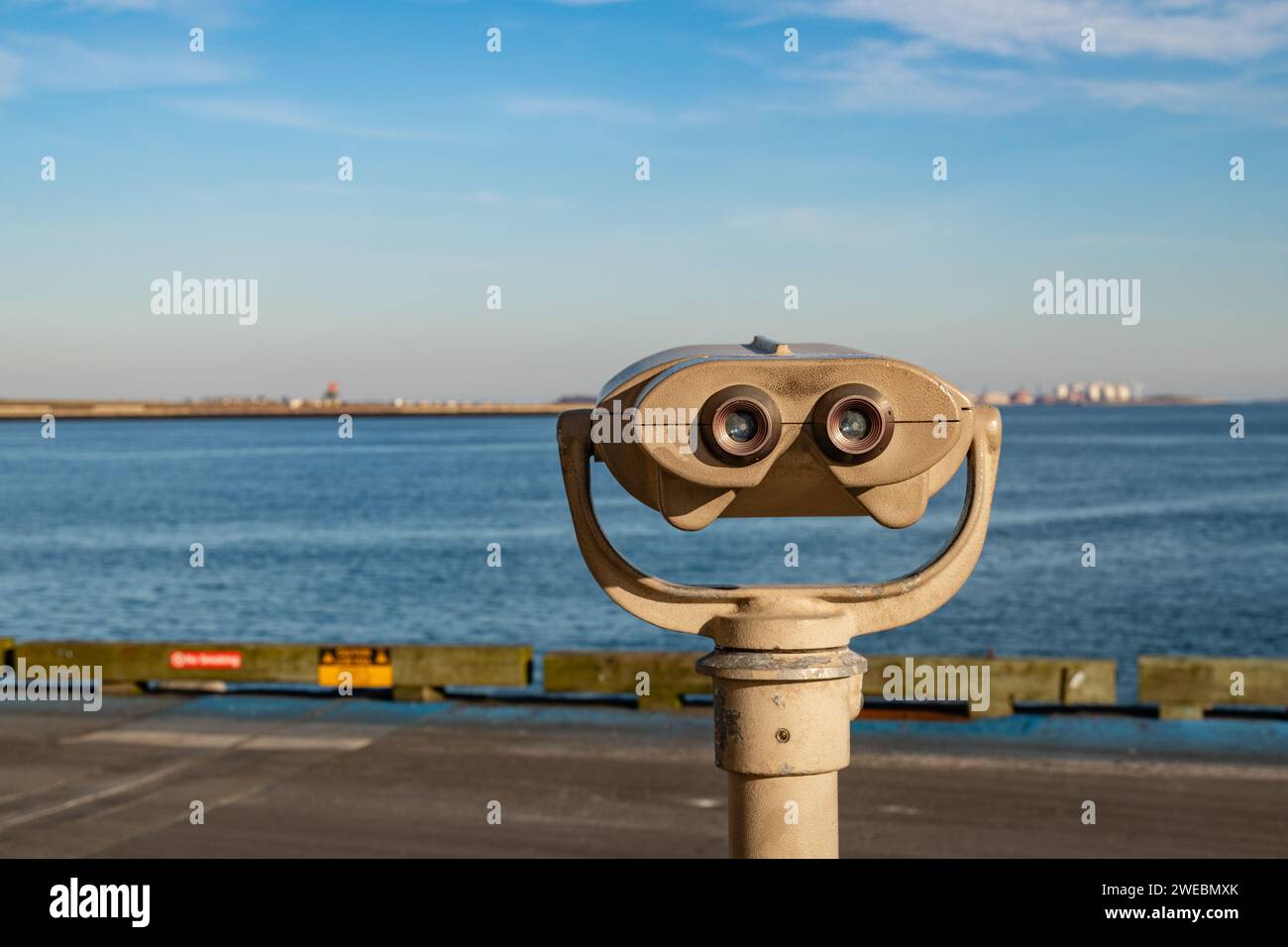 Boston, MA, US-December 8, 2023: Public viewing binoculars looking out onto Boston Harbor and Logan Airport. Stock Photo