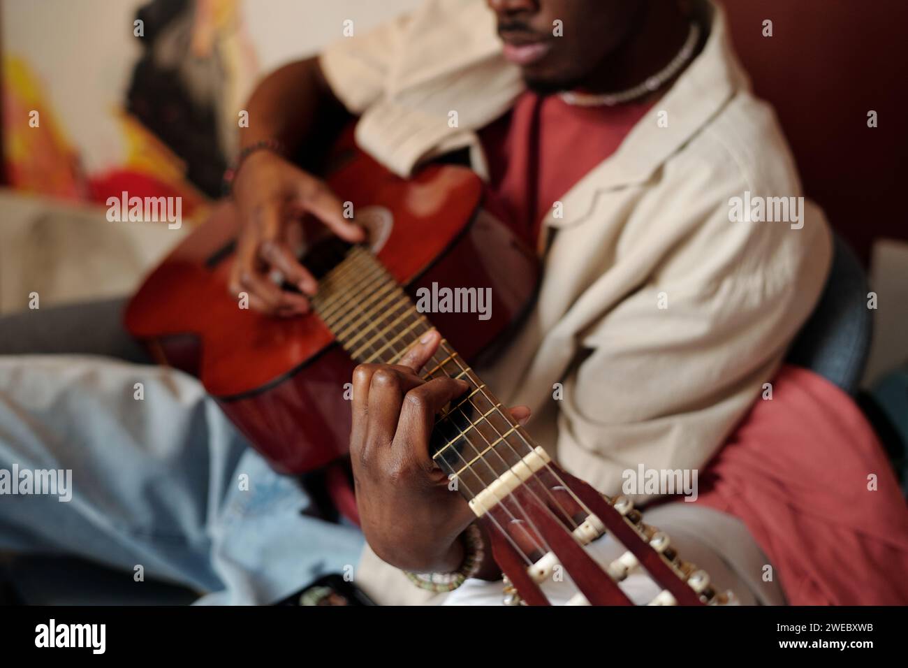 String Instruments While Playing Hand of young unrecognizable African American man playing acoustic ...