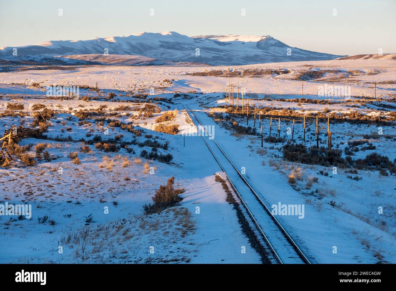 Railroad tracks in the snow running through Kemmerer, Wyoming, USA Stock Photo