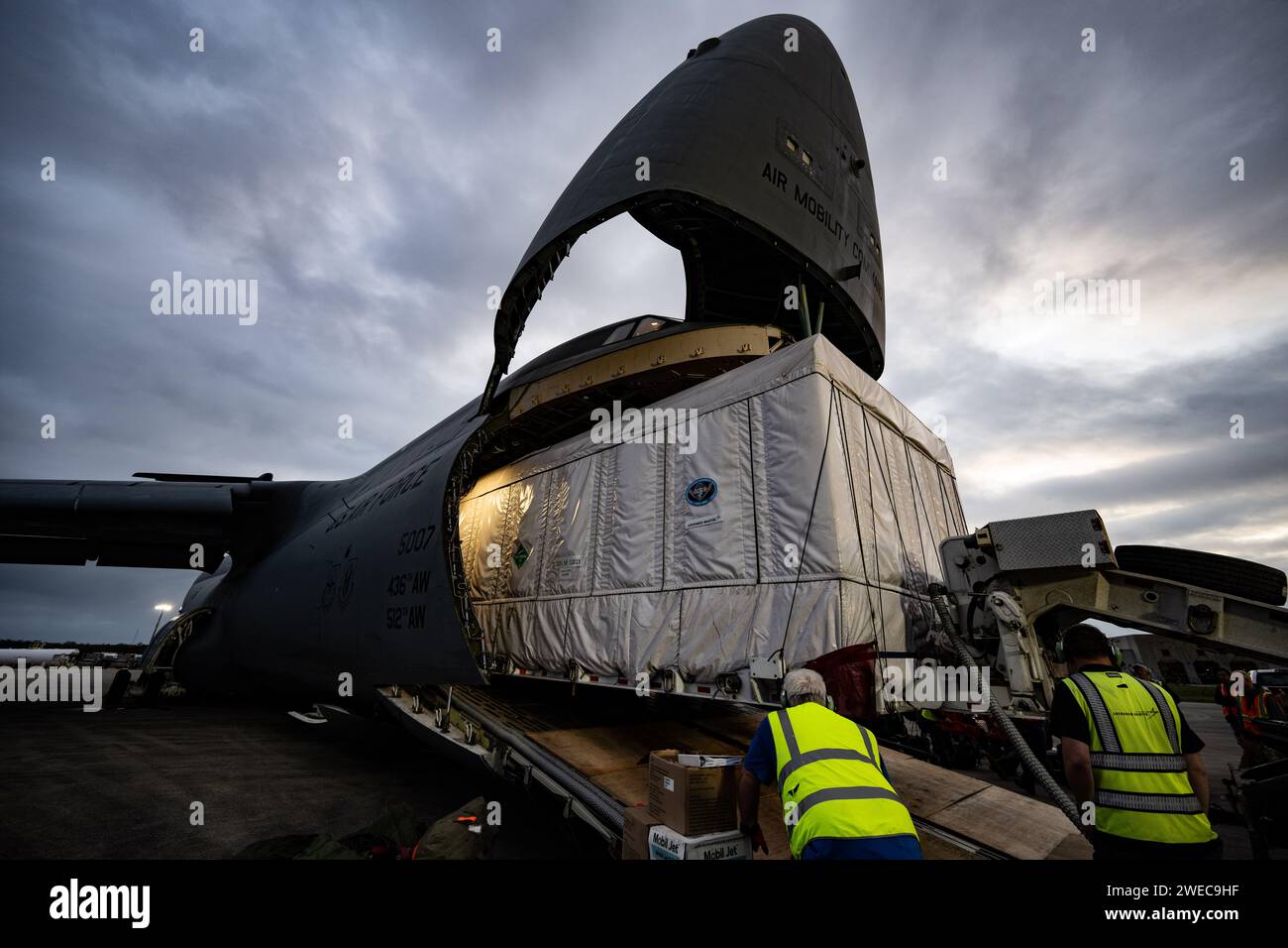 Lockheed Martin crew members monitor vehicle clearance while offloading ...