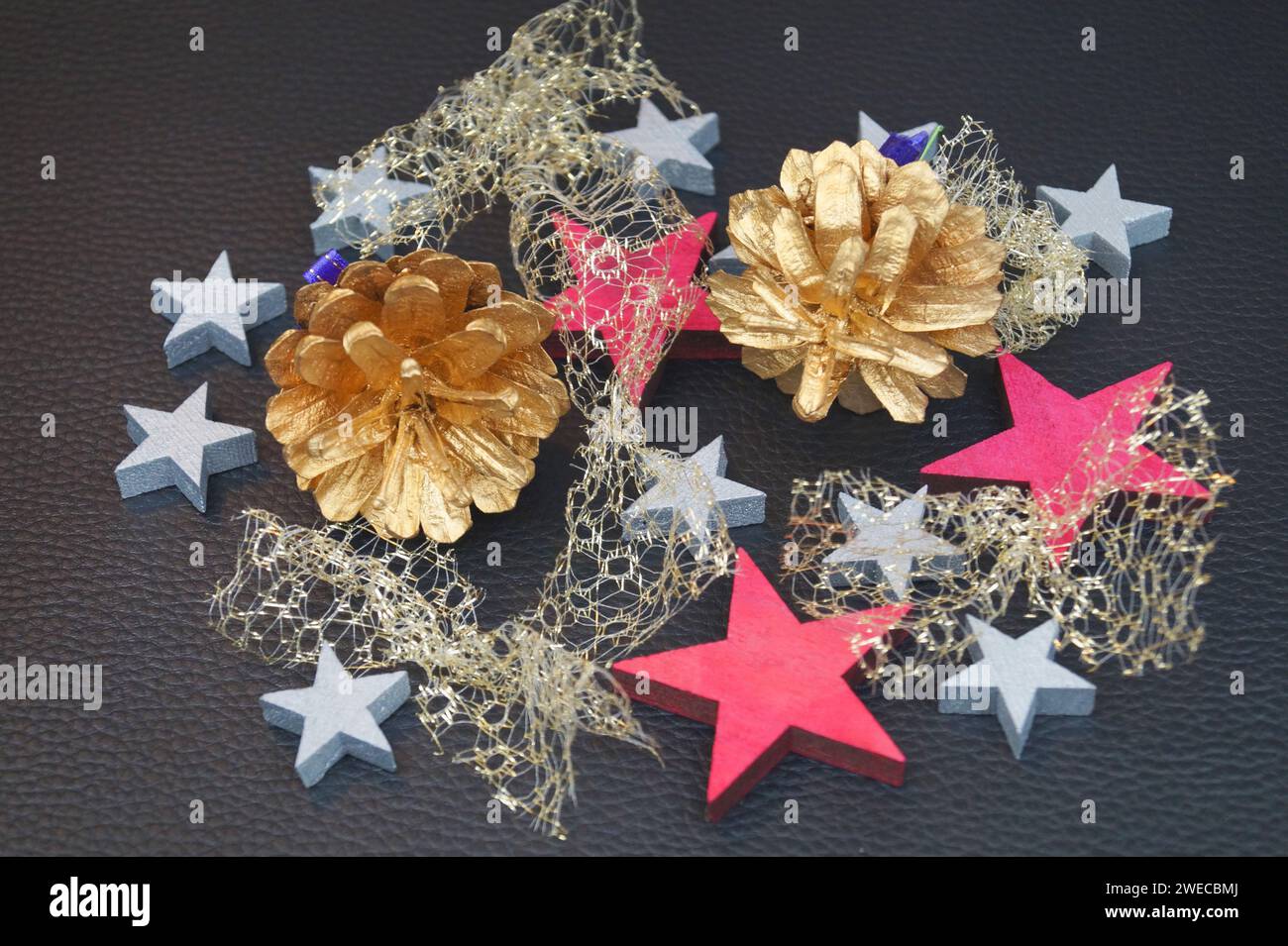 wooden stars with golden cones, Christmas decoration Stock Photo