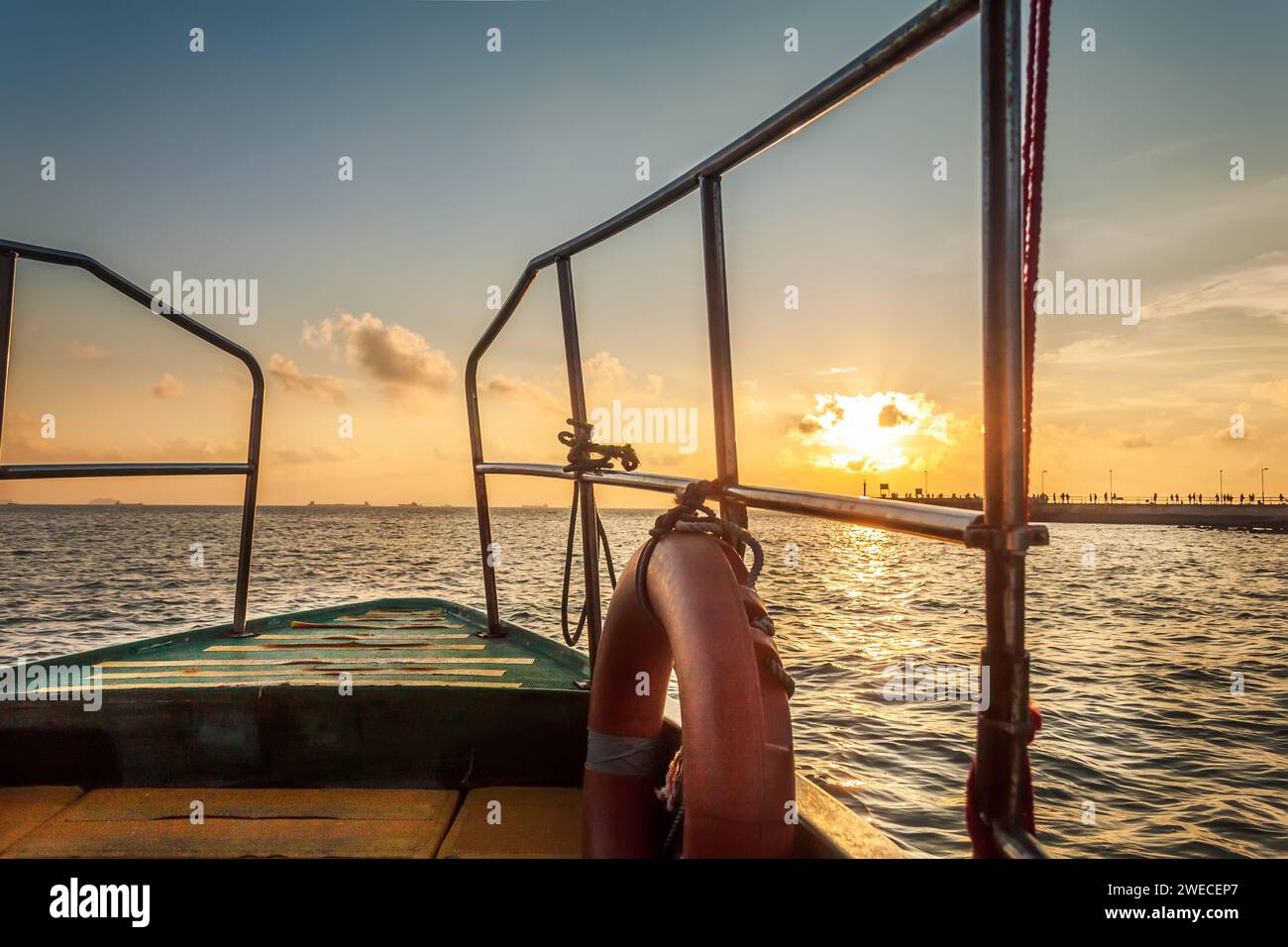 Fishing boat sailing at sunset hi-res stock photography and images - Alamy