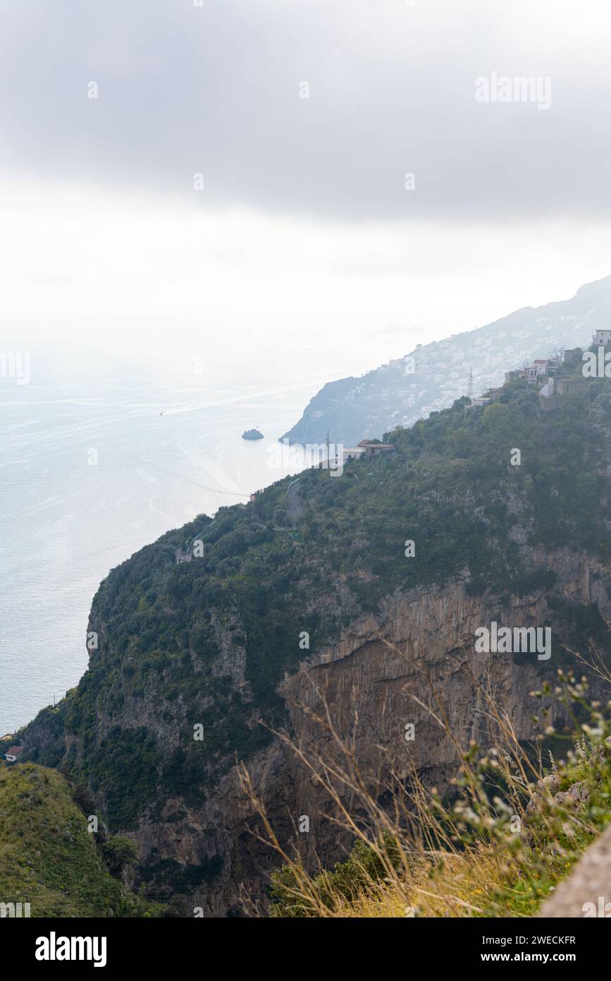 Photograph taken in a town near Sorrento, Italy, featuring a view of the lush green mountain, the sea, and the surrounding natural landscape Stock Photo