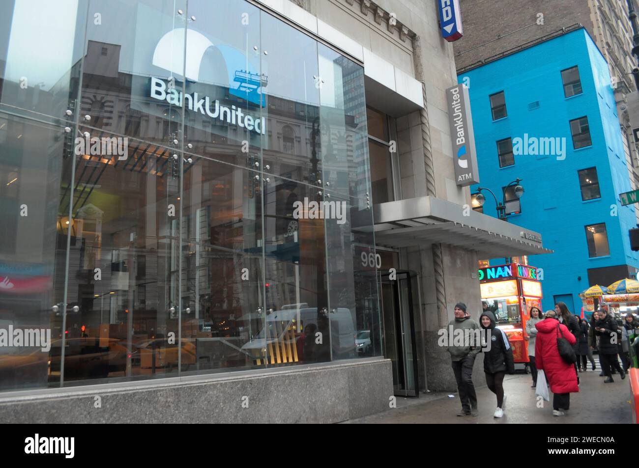 New York, United States. 24th Jan, 2024. Pedestrians walk past a