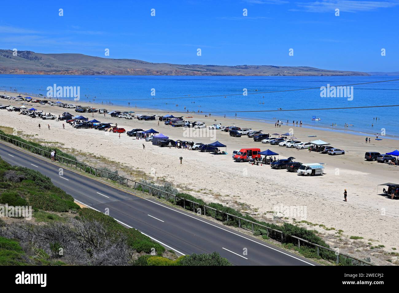 People enjoying the beach at Aldinga Bay during a hot summers day in