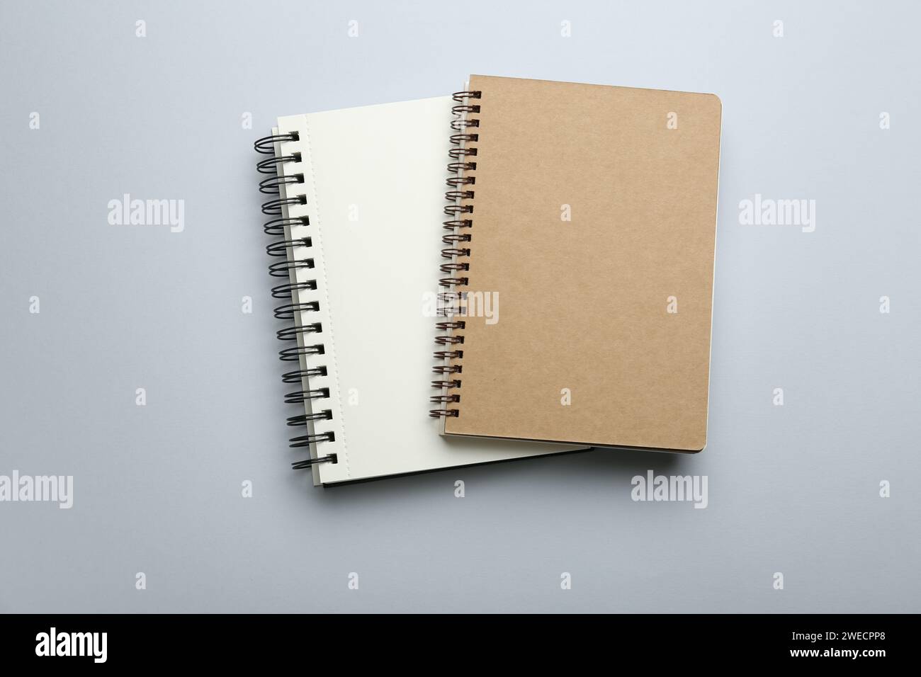 Notebooks on light grey background, top view Stock Photo