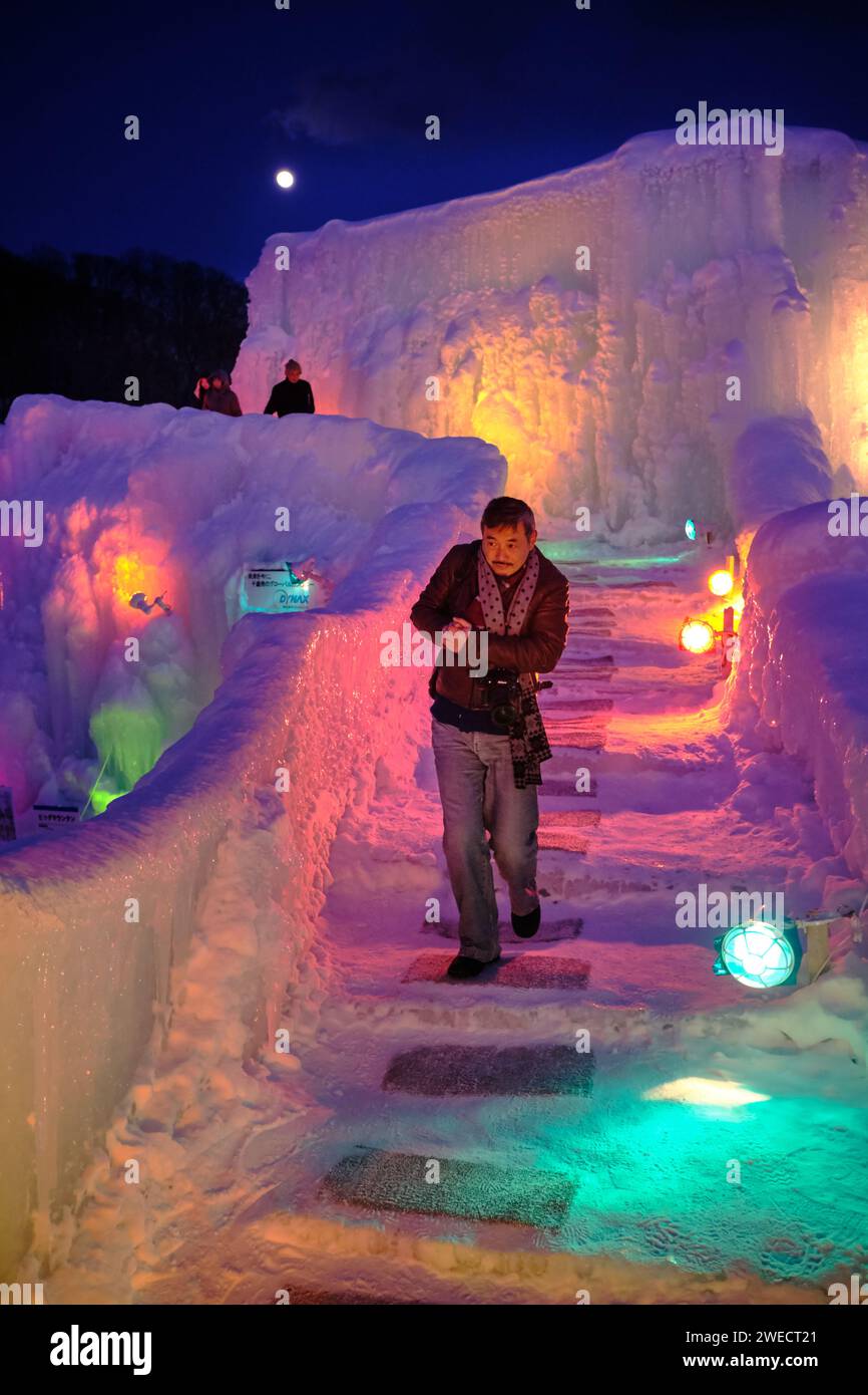 Chitose, Hokkaido, Japan - February 2018 : Man walking down ice steps ...