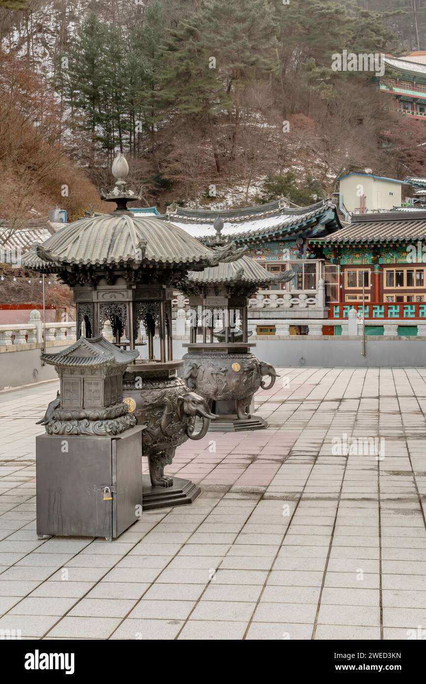 Two ornate metal incense candle burners on patio of Guinsa temple building in South Korea Stock Photo