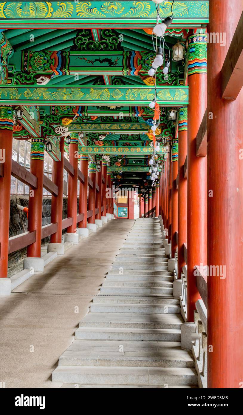 Colorful covered walkway with stairs and wheelchair ramp at Buddhist temple in South Korea Stock