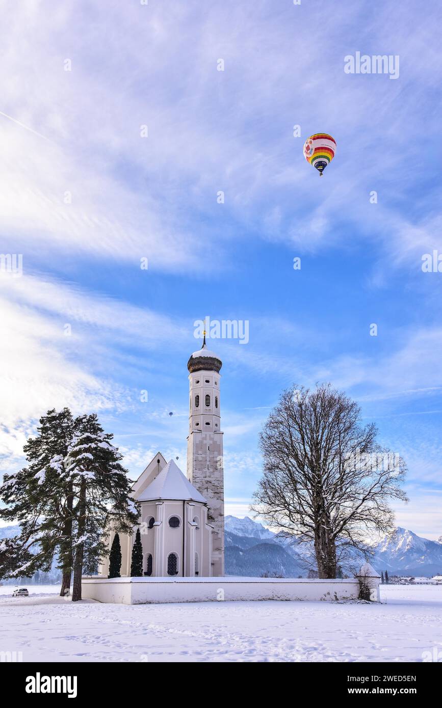 Hot air balloon over the pilgrimage church of St Coloman near Schwangau ...