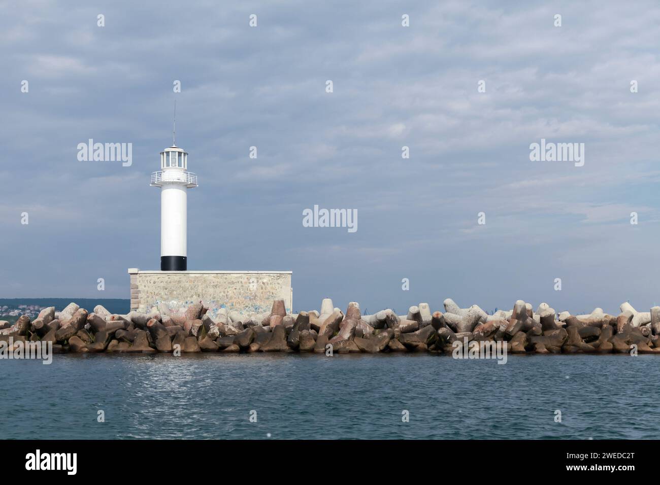 Breakwater with white lighthouse tower. Port of Varna, Bulgaria Stock Photo