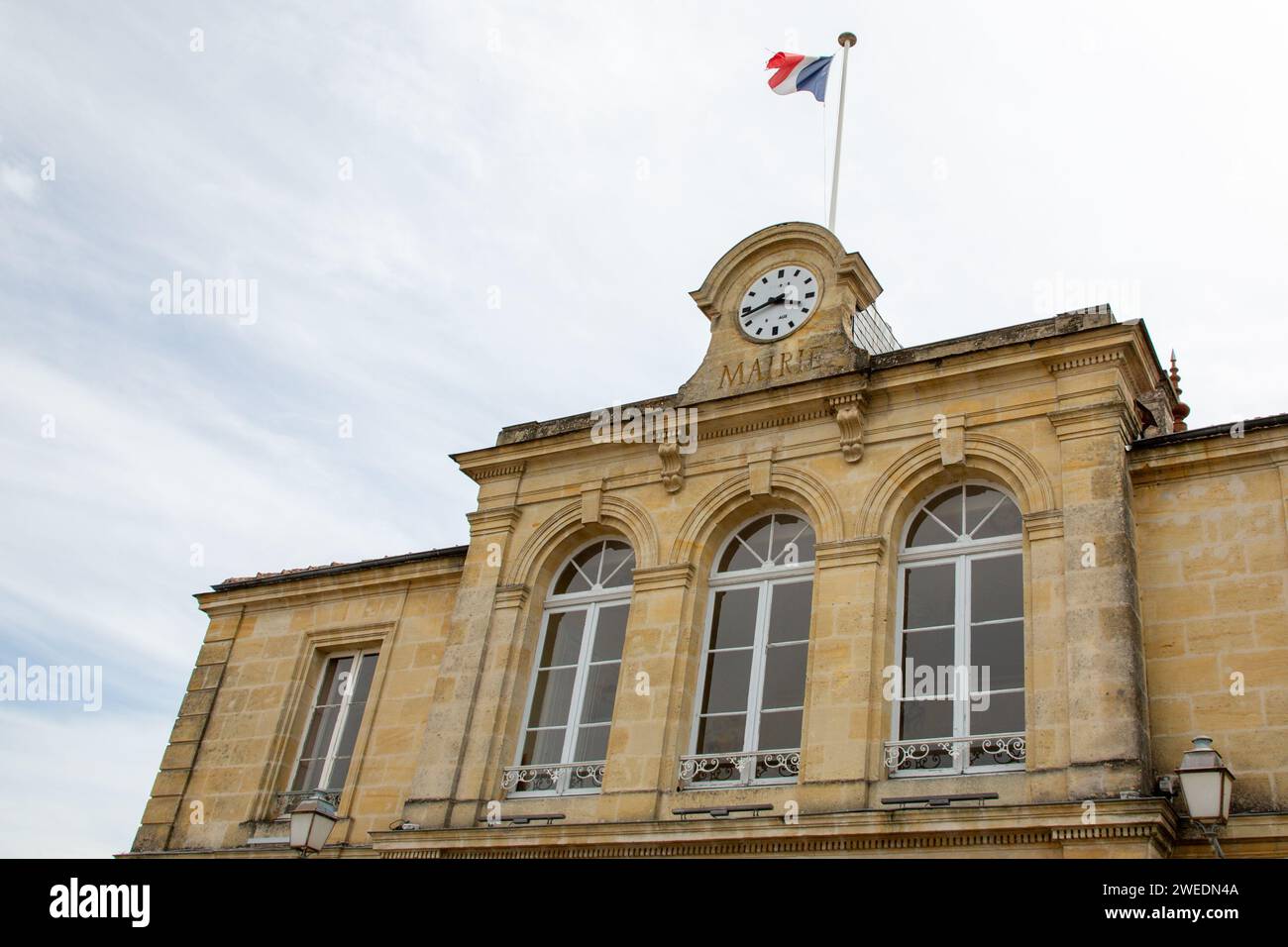 Saint-Caprais-de-Bordeaux city hall wall clock facade an clock sign french text mairie means town hall Stock Photo