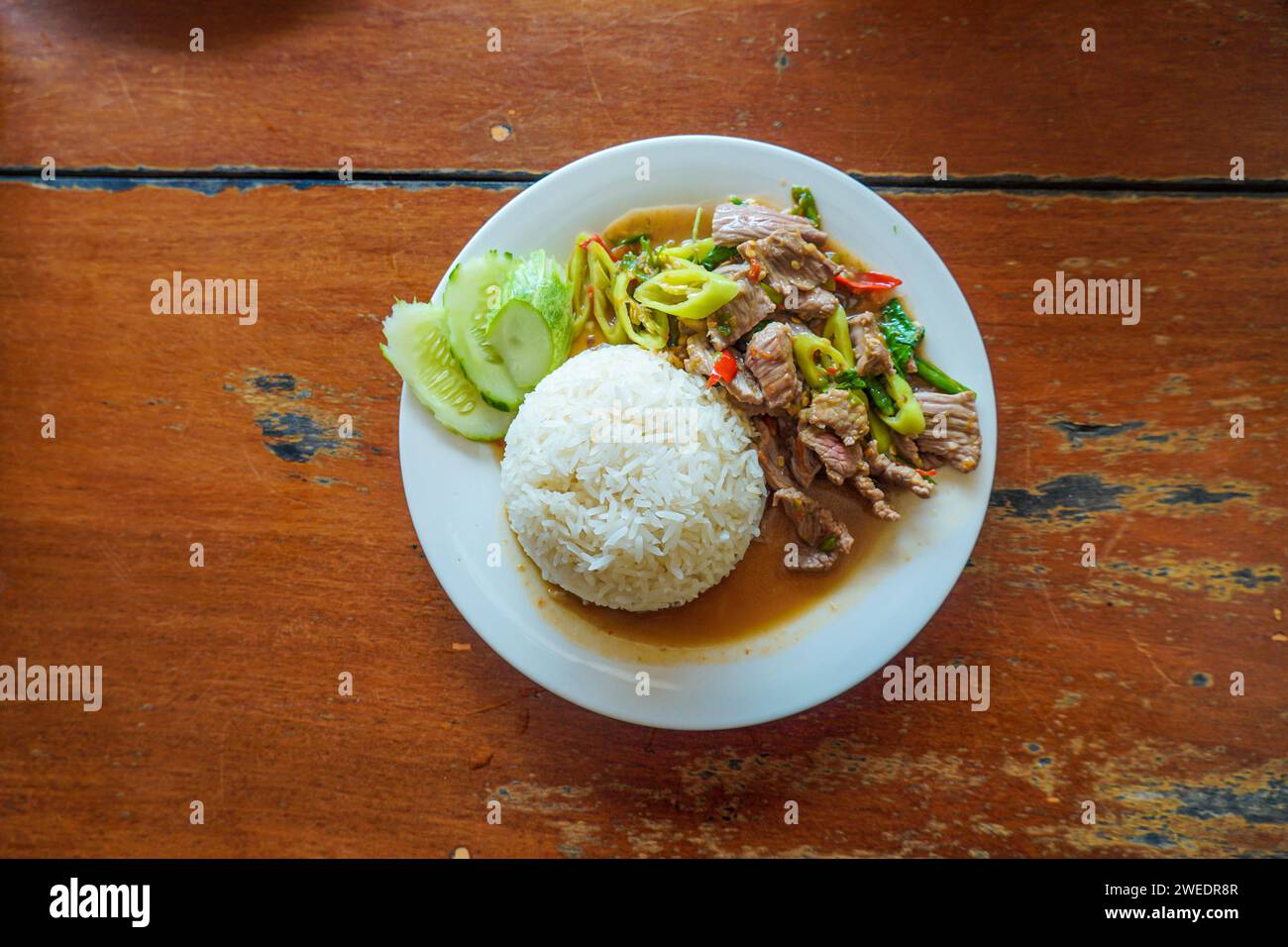 Rice topped with stirfried beef with holy basil. Fried beef with oyster sauce with chili and