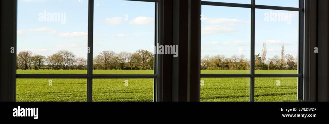 View of field through windows Stock Photo - Alamy