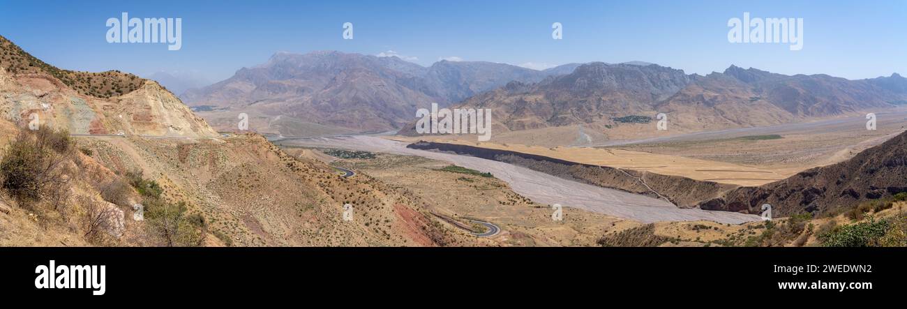 Pastel colored panoramic view of the Panj river valley towards Afghanistan in Darvaz district, Gorno-Badakshan, the Pamir region of Tajikistan Stock Photo
