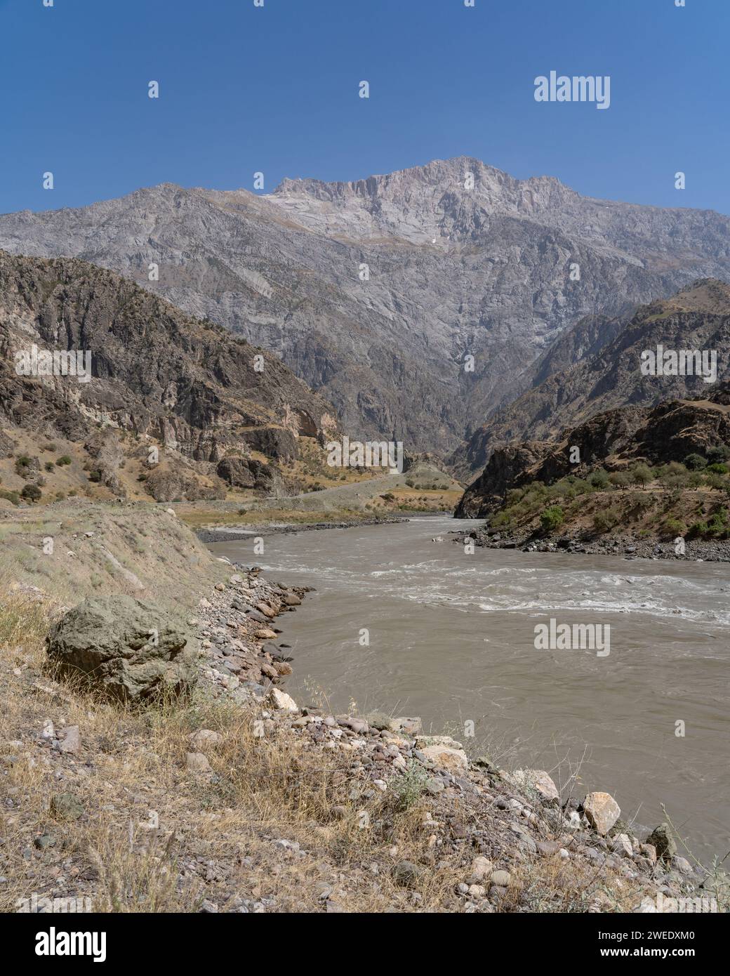 View of Panj river valley separating Tajikistan and Afghanistan taken in Darvaz district in Gorno-Badakshan, the Pamir mountain region of Tajikistan Stock Photo