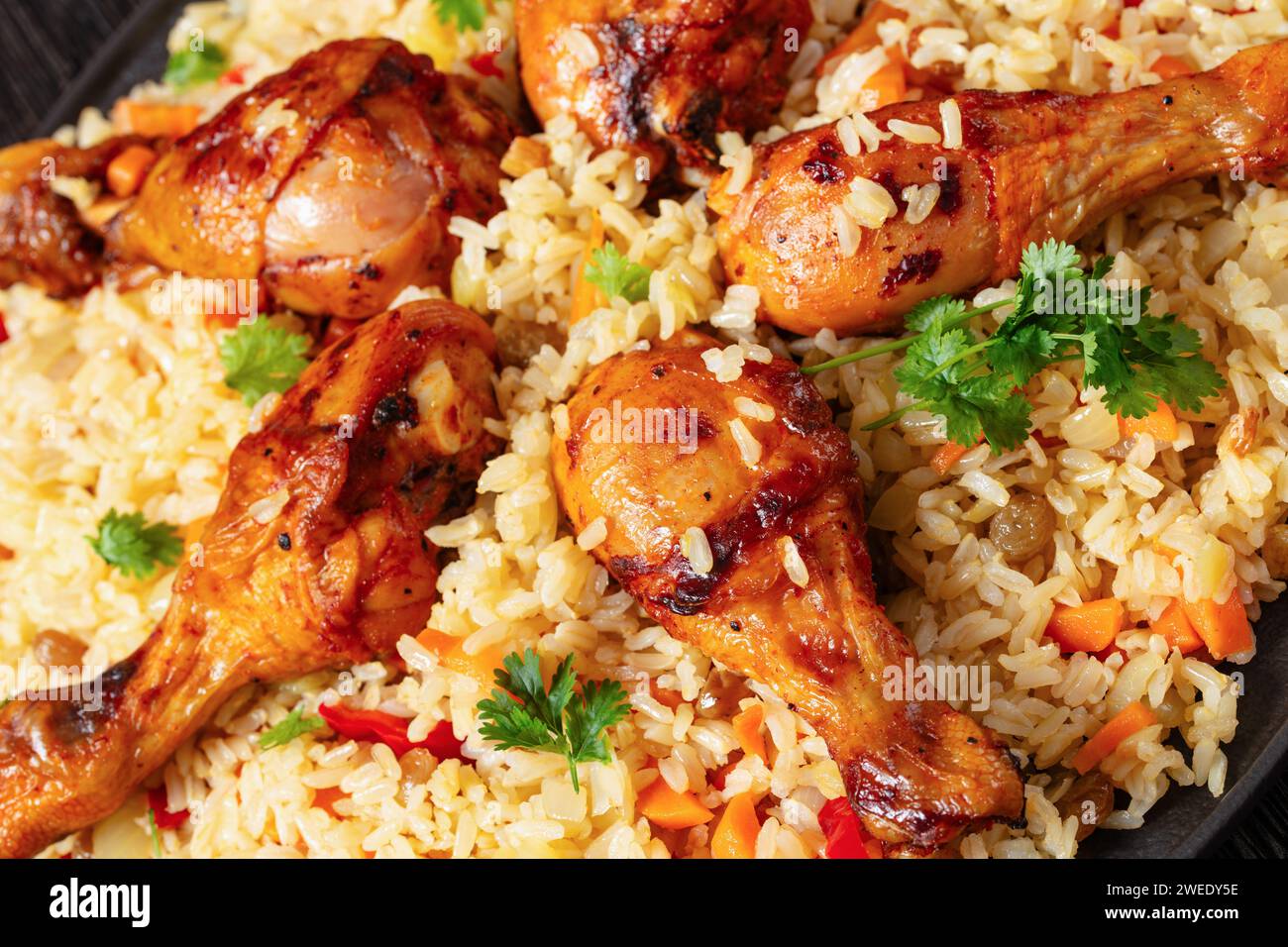 baked chicken drumsticks over brown rice pilaf with vegetables and